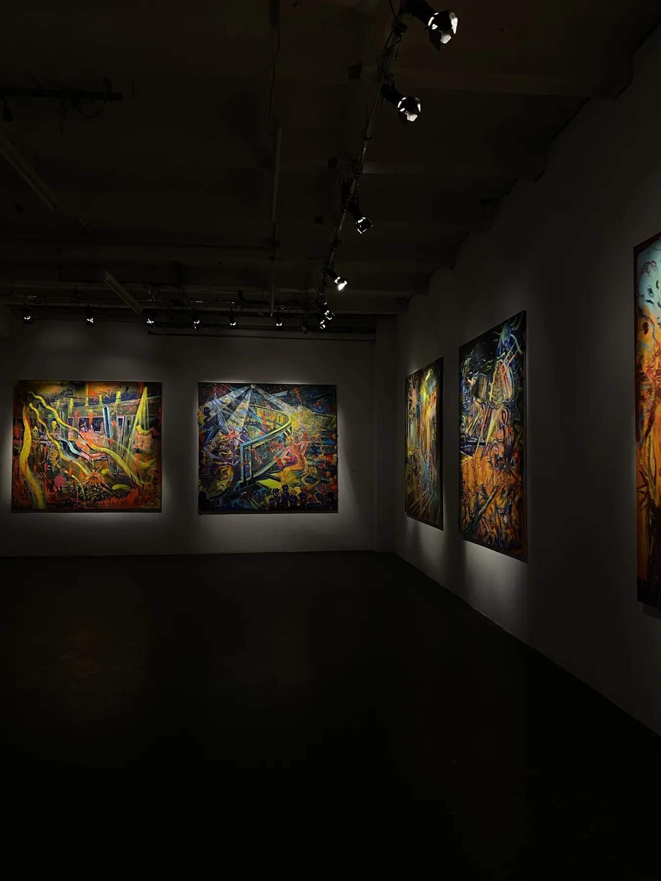 Paintings illuminated in a dark gallery