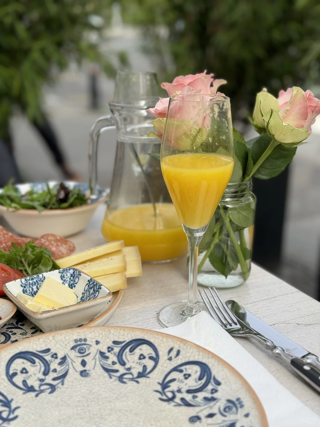 Breakfast table with flowers and fresh juice